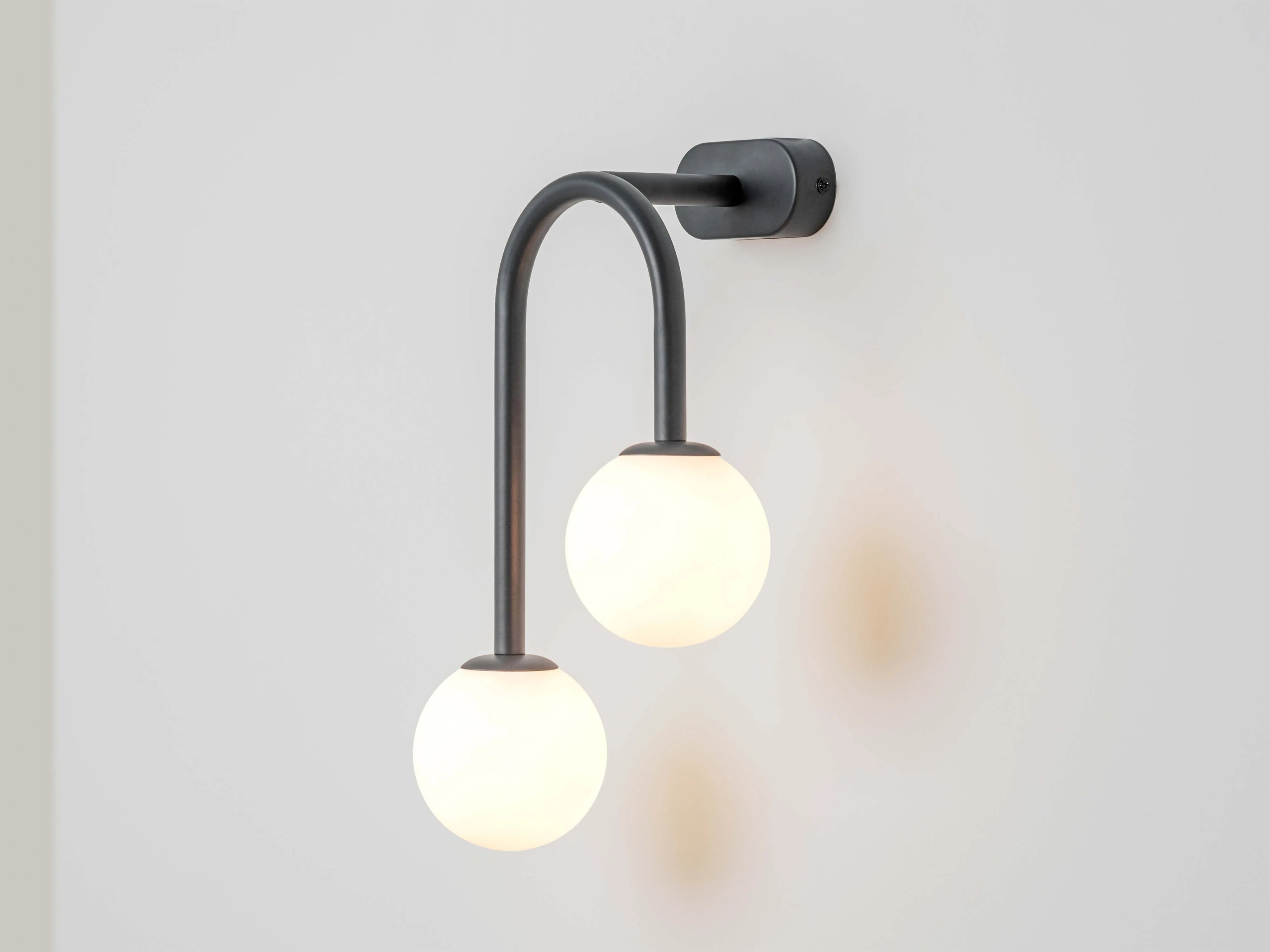 Charcoal grey drop curve wall light